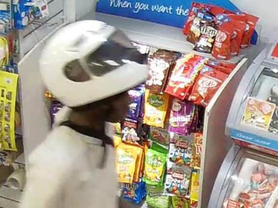 Derryck John, 17, in a Texeco petrol station, as he has been jailed at Wood Green Crown Court for 10-and-a-half years for carrying out a spate of acid attacks against moped riders in a bid to steal their vehicles. Photo credit: Metropolitan Police/PA