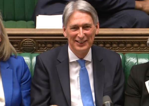 Chancellor Philip Hammond enjoys a joke during his Spring Statement