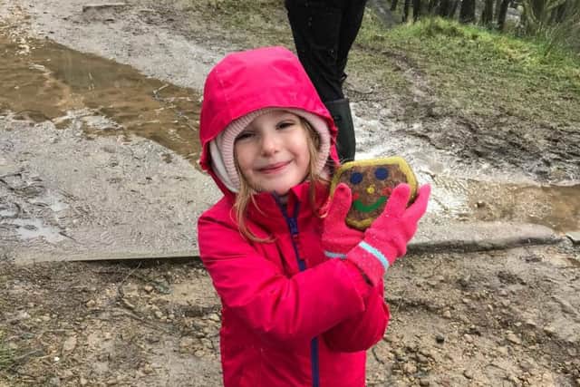 Lexi Barker, eight, finds one of the decorated stones