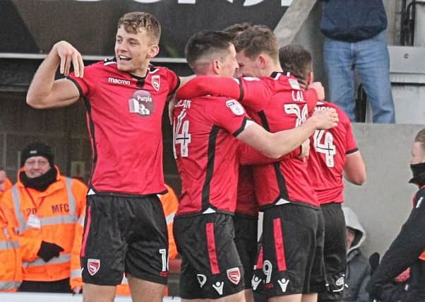 Morecambe celebrate Michael Rose's winner against Exeter last Saturday.