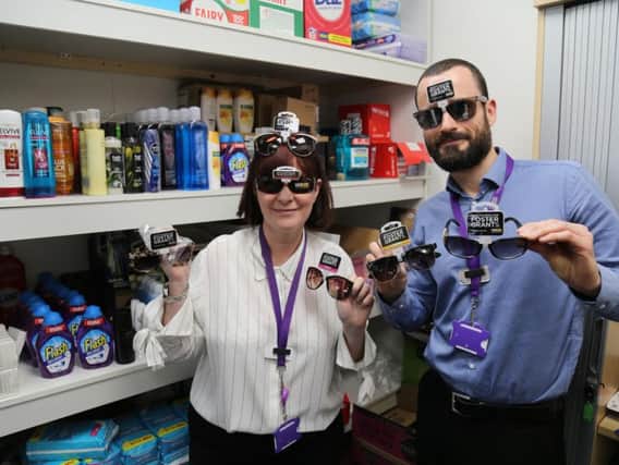 Two members of the CGA modelling the glasses donated by Well Pharmacy at their office in Preston