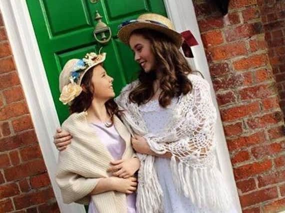 Megan Hill as Beth and Erin Bannister as Jo in Clifton Academy's production of Little Women