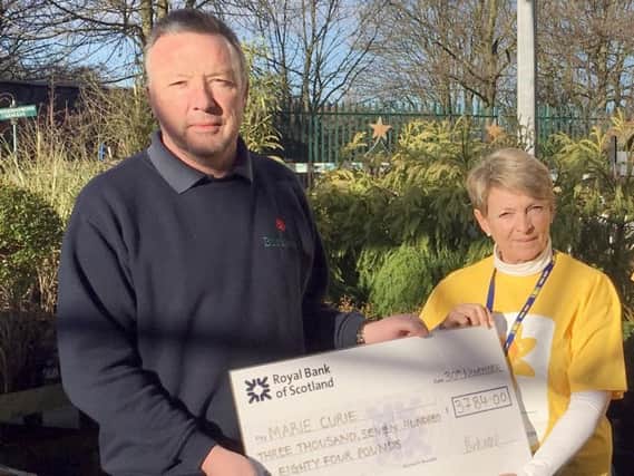 Birkacre Garden Centre Managing Director Stephen Ainscough (left) presents a cheque for 3,784 to Marie Curie