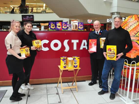 Preston Costa staff with the donated Easter eggs, with John Gibson and representative from The Salvation Army