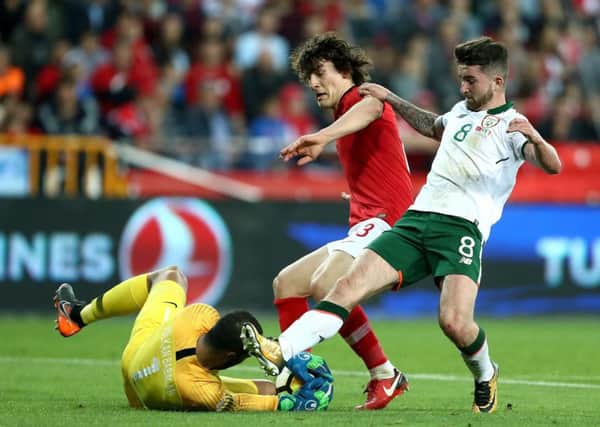 Turkey's Caglar Soyuncu (centre), goalkeeper Volkan Babacan (left) and Republic of Ireland's Sean Maguire (right) battle for the ball during the international friendly match at the Antalya Stadium.