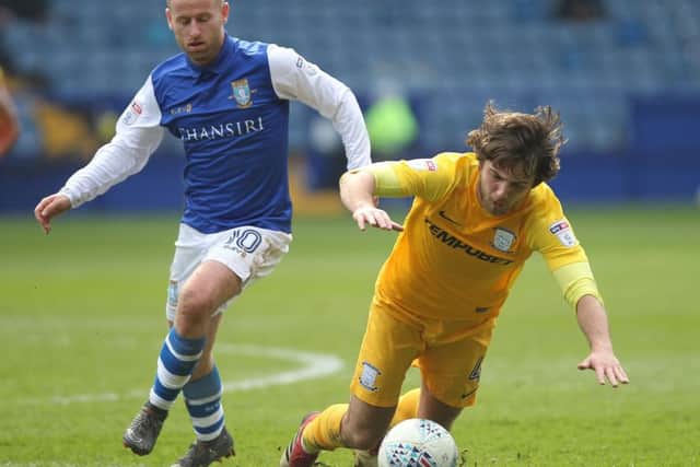 Ben Pearson battles with Barry Bannan during PNE's defeat to Sheffield Wednesday.
