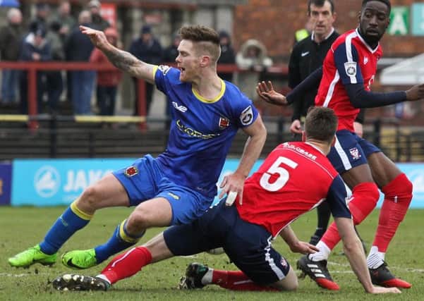 Action from Saturday's 1-1 draw at York as Jason Walker is brought down (photo: Josh Vosper)