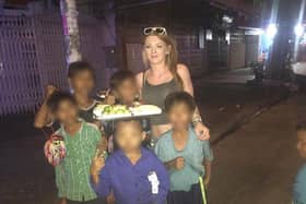 Ellis Matthews with children in Cambodia