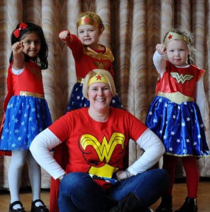 Reception class pupils at Cop Lane CE Primary School, Penwortham, dressed up as their favourite super heroes to mark the end os a special learning topic. The class have spent two weeks learning all about super heroes both real life and fictional as part of the topic. Wonder Woman class teacher Gail Barnes with l-r Shreya, Sienna and Lilly-Jay. Picture by Paul Heyes, Wednesday February 28, 2018.