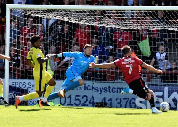 Garry Thompson's two goals gave Morecambe victory over Cheltenham Town on the opening day of the season