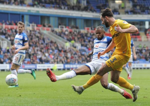 Preston North End's Greg Cunningham crosses despite the attentions of Reading's Leandro Bacuna