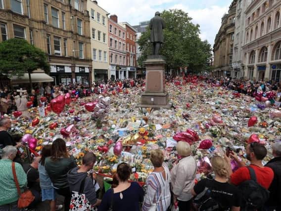 Flowers and tributes left in St Ann's Square in Manchester following the Manchester Arena terror attack. Credit: Danny Lawson/PA