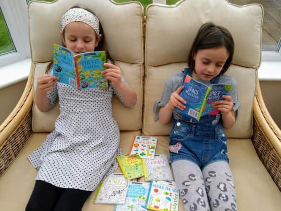 Isabelle and Jessica Kidd choose their Usborne Mini puzzle books