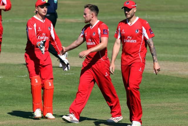 Danny Lamb, centre, is congratulated on taking the wicket of Mark Cosgrove on his T20 debut against Leicestershire