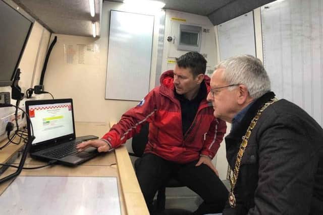 Deputy Team Leader, Julian Earnshaw, shows the Mayor Search software in the Control vehicle.