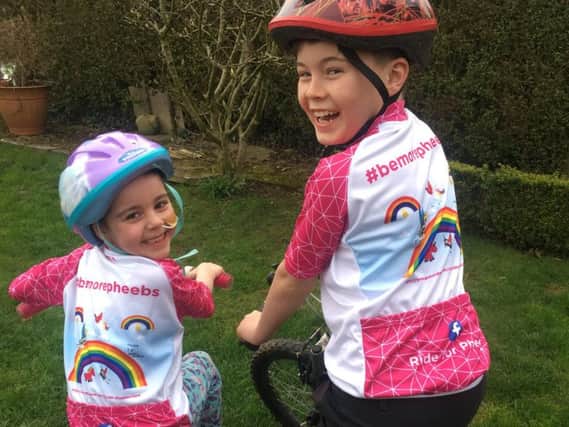 Phoebe Roskell with brother Woody in the cycling tops that the team will wear.