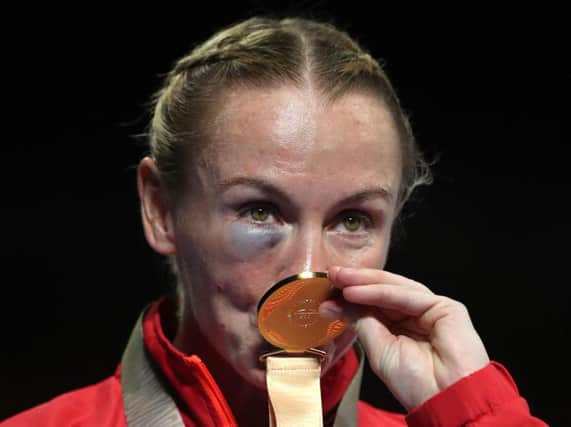 Lisa Whiteside kisses her Commonwealth Games gold medal