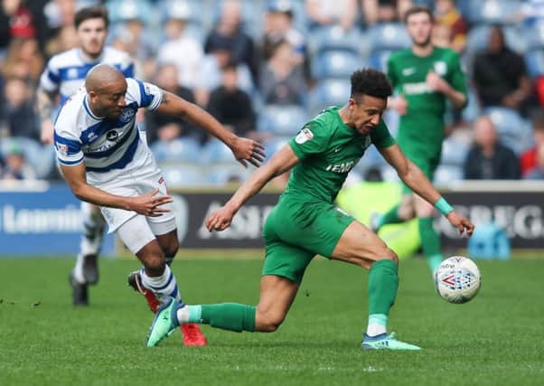 Callum Robinson shields the ball from former North End loanee Alex Baptiste during PNE's 2-1 win over QPR