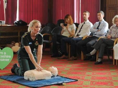 Cheryl Pickstock demonstrates  CPR to  those attending a Lancashire Lifesavers course .