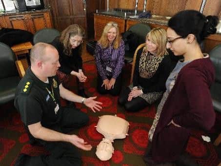Four "students" attending the Lancashire Lifesavers course get advice from Community Resuscitation Manager Chris Hyde