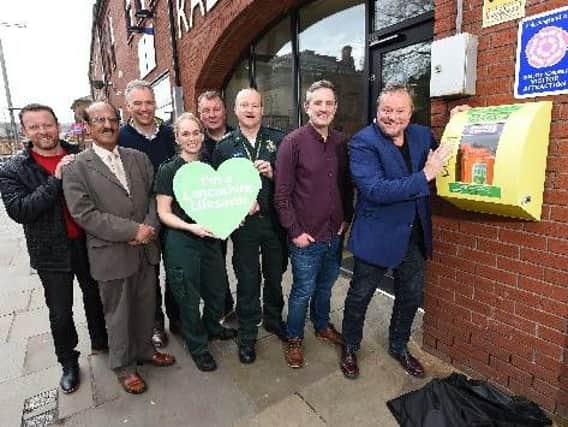 Ted Robbins unveils a new defibrillator as part of the Lancashire Lifesavers campaign.