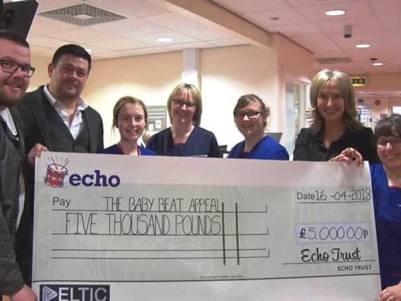 Jon Walling and Leigh Sweetman from Evoque, hand over a cheque to the Baby Beat Appeal: Laura Davidson, specialist bereavement midwife,  Marie Ryan, maternity ward manager,  Emily Leeder, midwife, Karen Entwistle, head of The Baby Beat Appeal, and Lourdes Siquier, midwife.