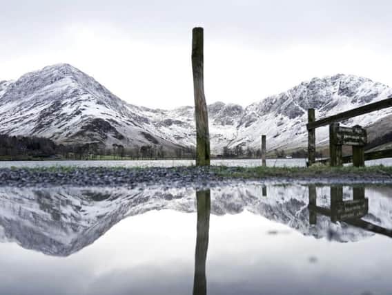Snowy mountains reflected in Buttermere Lake in the Lake District