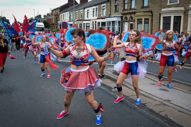 Dancers perform their routines along Deepdale Road