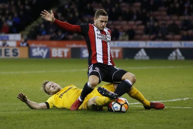 Clarke brings down Billy Sharp to give away a penalty during the FA Cup fourth round defeat at Bramall Lane in January
