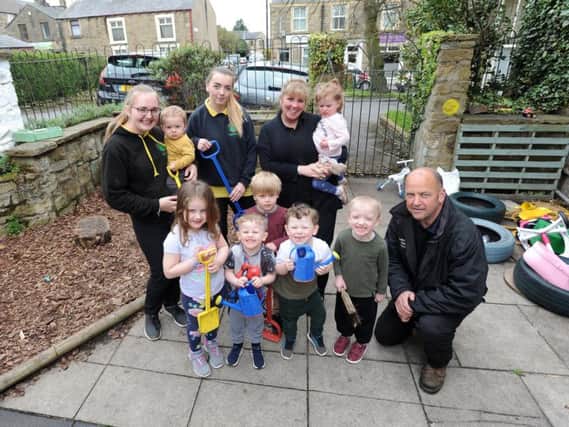 Staff and children from The Little People at the Limes nursery with Louis Hunt from Lancashire Garden Services