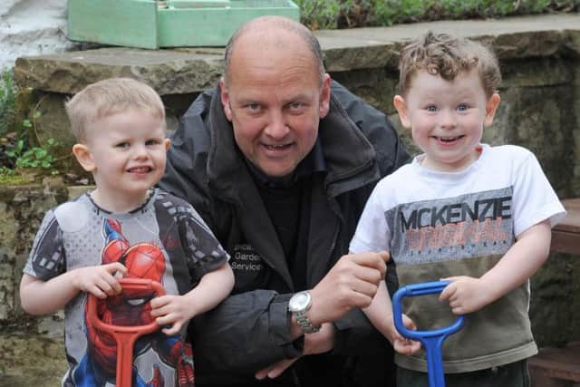 Lucas Greenwood-Prior, 3 and Charlie Makinson, 4 with Louis Hunt from Lancashire Garden Services.