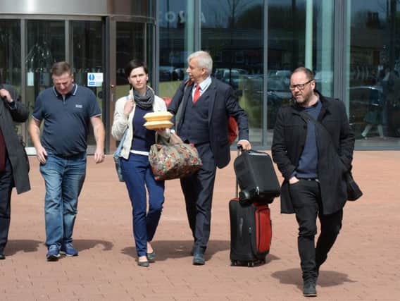 A man and woman (both centre), believed to be members of a German air ambulance crew, exit Liverpool's Alder Hey Children's Hospital after they were asked to leave the hospital