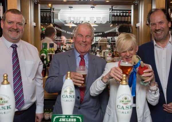 Gina Cambell with her father's mascot and (l-r) Peter Toft, general manager of the Bluebird Inn, Christopher Lees-Jones and William Lees-Jones.
