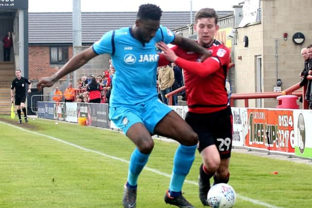 Callum Lang battles for the ball in Morecambes defeat to Barnet