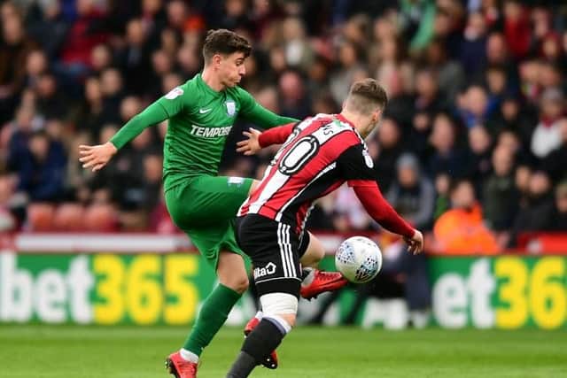 Josh Harrop tussles with Lee Evans in PNE's clash with Sheffield United