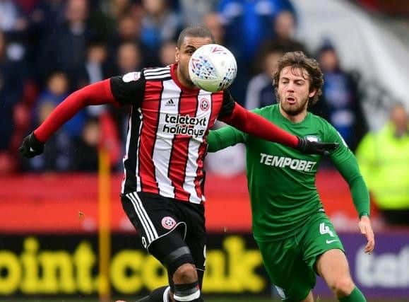 Ben Pearson and Leon Clarke compete for the ball