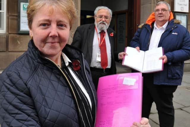 Patricia Varty hands in a petition at the town hall last year