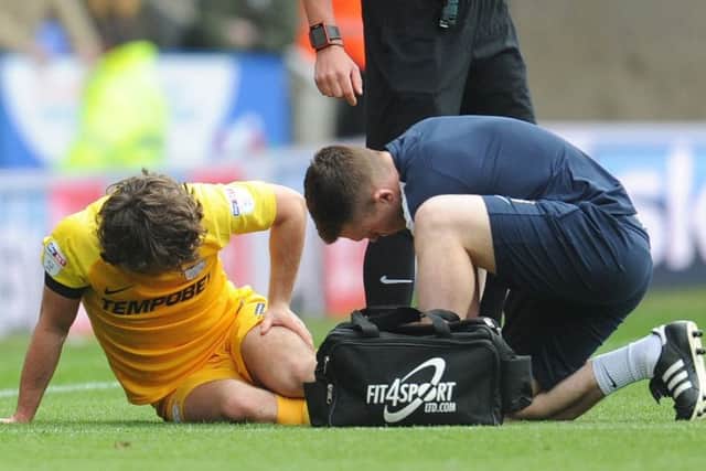 Ben Pearson receives treatment from physio Matt Jackson during PNE's defeat at Reading