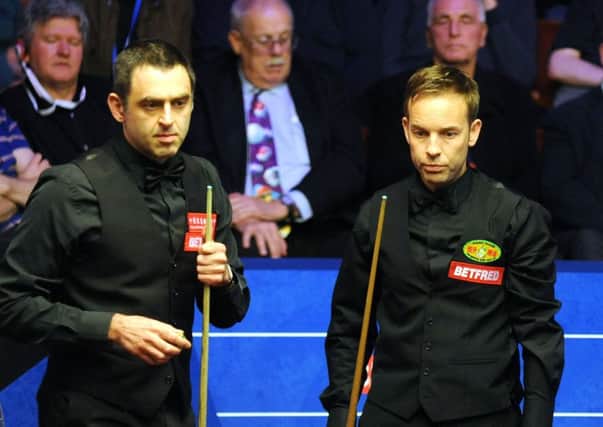 Ronnie O'Sullivan and Ali Carter during their second-round clash at the World Snooker Championships in Sheffield