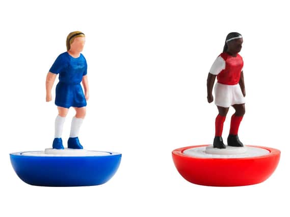 Figures in the colours of Chelsea (left) and Arsenal from the first all-female Subbuteo set