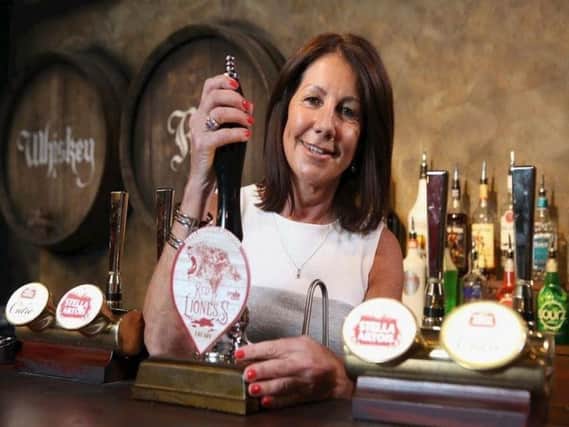 Cathy Price, 59, from Preston, samples the Red Lioness beer, a guest ale named in her honour
