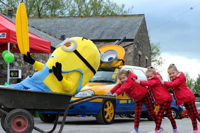 Minion with triplets Neve, Isla and Jessica Livesey, aged five