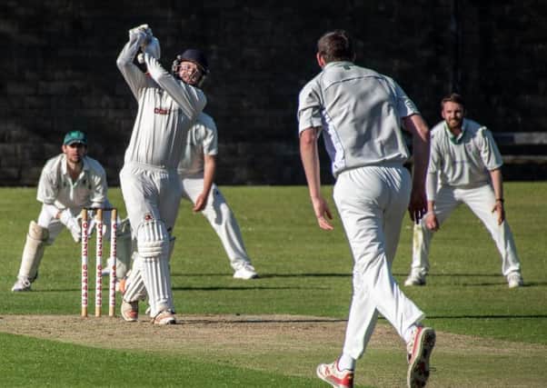 Garstang's Michael Wellings hits a six in his knock of 41 against Leyland at Riverside on Saturday. Photo by Tim Gilbert (Preston Photographic Society)