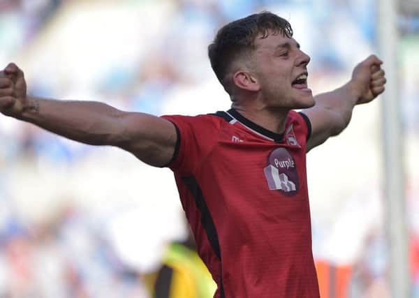 Sam Lavelle celebrates Morecambe sealing survival on the final day at Coventry. Picture: B&O PRESS PHOTO