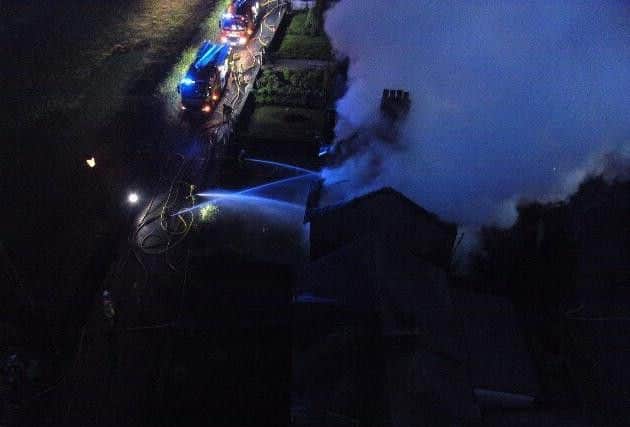 Aerial pictures show smoke pouring from the properties