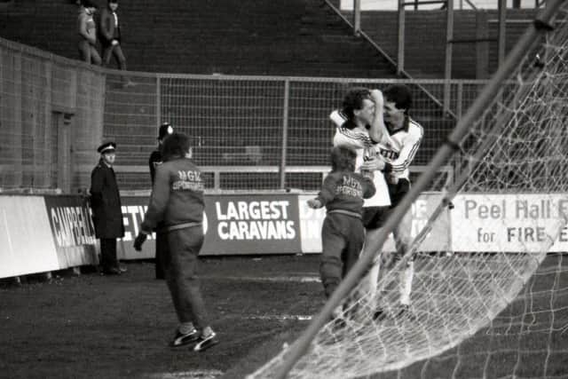 Alex Bruce is congratulated by Steve Elliott after scoring against Wigan on January 1, 1983