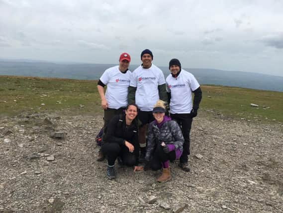 Front row from the left, Ceri Kay and Lauren Brindle with, back row from the left, Dan Alvarez, Chris Conlan and Steve Wignall at the summit of Ingleborough, the final of the three peaks they climbed in aid of Rosemere