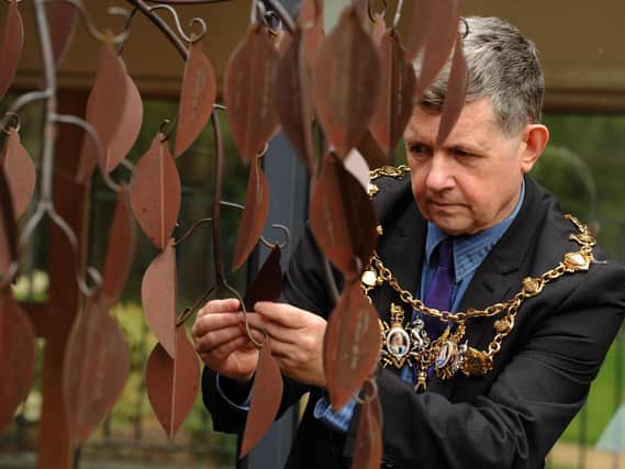 Chorley Mayor, Coun Mark Perkins looks at Derian Houses Legacy Tree  with details of charitable donations