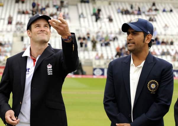 Former England captain Andrew Strauss tosses the coin while ex-India skipper MS Dhoni calls heads or tails before a Test match at Trent Bridge