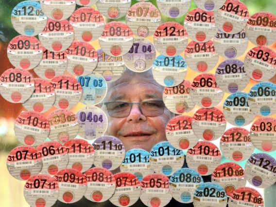 Robert Watkinson pictured with part of his tax disc collection